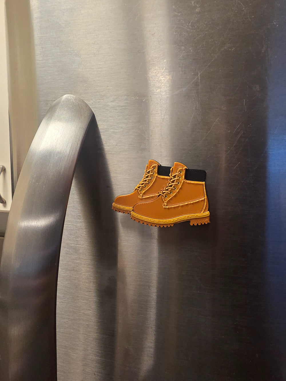 Boots 3D printed refrigerator magnet on stainless steel refrigerator