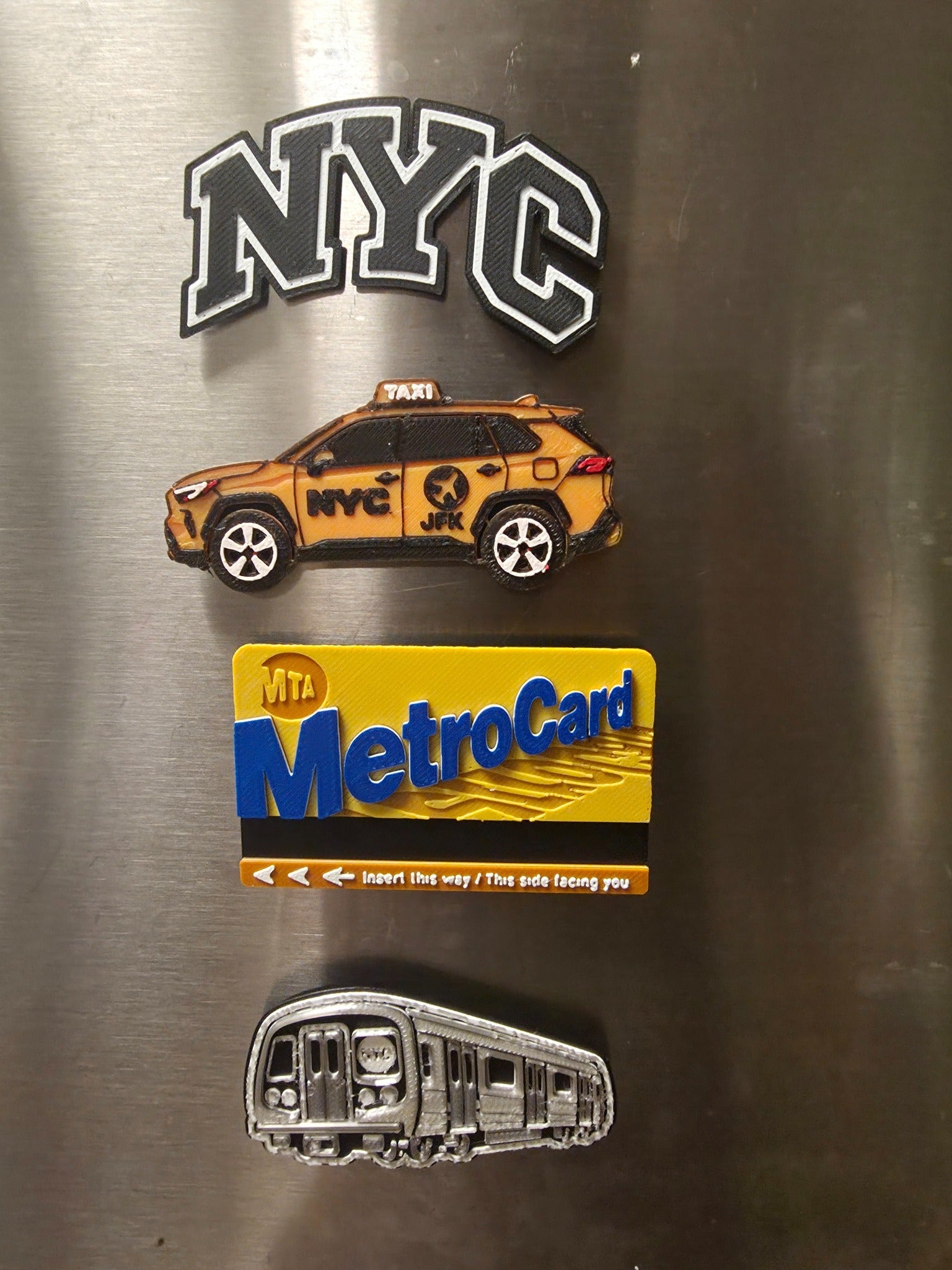 NYC Travelers Pack 4-piece 3D printed magnet set with NYC letters, yellow taxi, MetroCard-style card and subway train